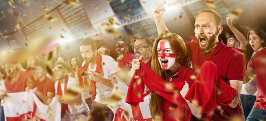 Emotive football, soccer fans from England cheering their team with white red scarfs at stadium....