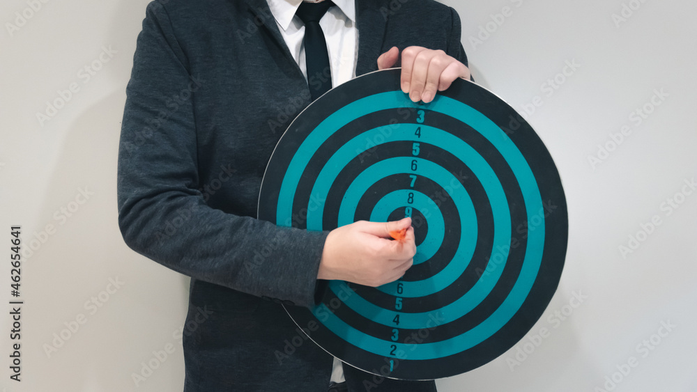 Poster close up shot of the dart arrow hit on bulleyes of dartboard to represent that the business reached 