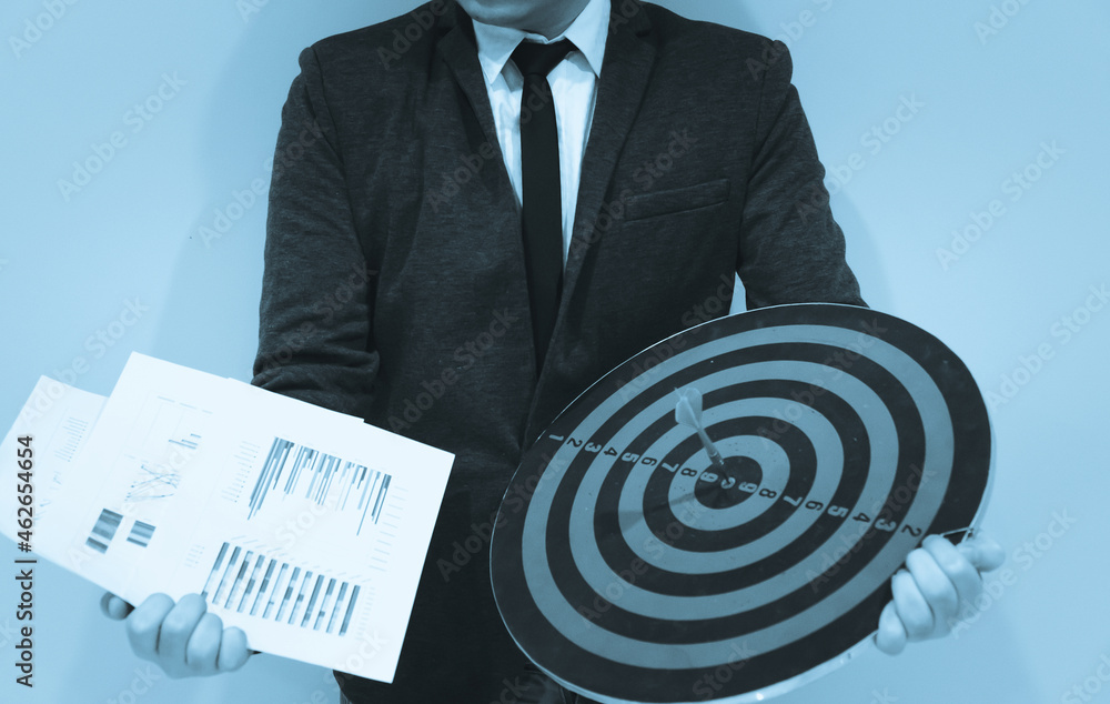 Poster close up shot of the dart arrow hit on bulleyes of dartboard to represent that the business reached 