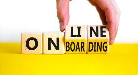 Online onboarding symbol. Businessman turns wooden cubes with words 'online onboarding'. Beautiful yellow table, white background, copy space. Business, online onboarding concept.