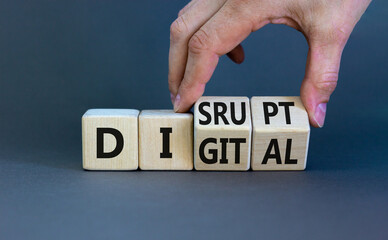 Digital or disrupt symbol. Businessman hand turns cubes and changes the word 'digital' to 'disrupt'. Beautiful grey background. Business digital or disrupt concept. Copy space.