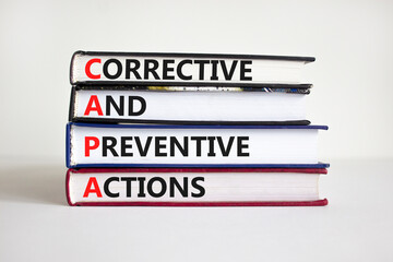CAPA synbol. Concept words 'CAPA, corrective and preventive actions' on books on a beautiful white...