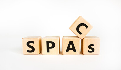 SPACs, special purpose acquisition companies symbol. Cubes with words 'SPACs, special purpose acquisition companies' on beautiful white background, copy space. Business and SPACs concept.