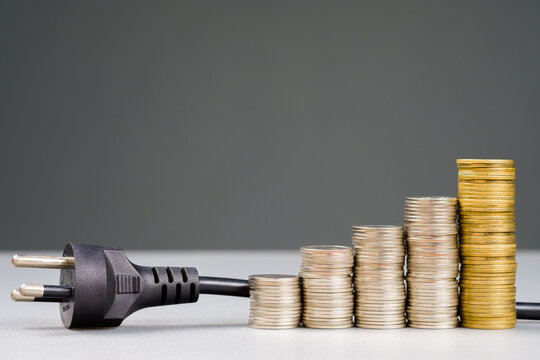 Electronic plug and growth money coins, how to reduce the electricity bill and save the more money, electricity and economy concept