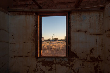 One of the dilapidated rooms of the hotel in the railway village called Putsonderwater in South Africa. Room with a view.