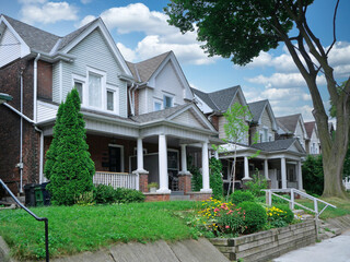 Residential street with brick semi-detached houses with clapboard gables