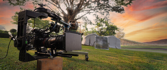 Movie Camera. Behind the video camera that for recording film commercial or movie at outdoor...