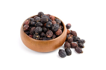 Dried rose hips in wooden bowl isolated on white