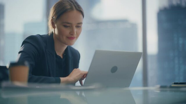 Close Up Low Angle Portrait of a Beautiful Businesswoman Working on Laptop in Open Office, Confident Female CEO Analyze Financial Projects. Manager Smile at Work while Using Social Media.