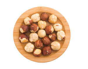 plate with hazelnuts on white background