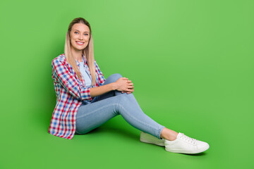 Full size profile side photo of young woman happy positive smile sit floor isolated over green color background