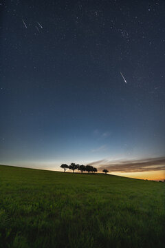 perseids over rural landscape