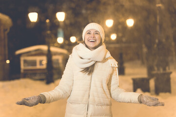 Girl in a night city snowflake Christmas city lights. Christmas and winter holidays concept.