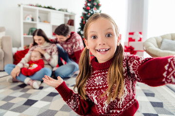 Photo of sweet charming big family wear christmas sweaters sitting under tree recording self video smiling indoors room home house