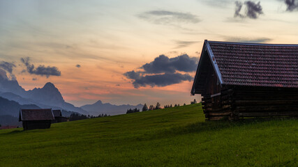 Alpine huts at sunset