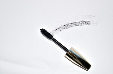 Smudged black mascara isolated on white background. Cosmetic product swatch. Paint brush stroke