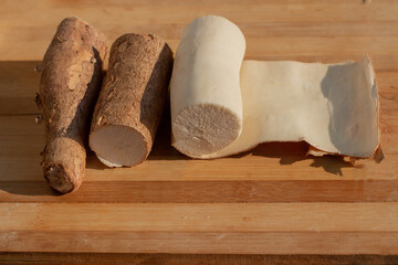 Cassava being peeled on a cooking board