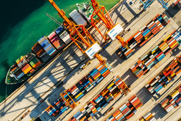 Containers in international shipping dock waiting to import or export and transportation. Top view of loading containers on the ship in the port