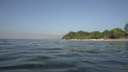 ocean view to island Gili Indonesia sunny day horizon boat trip diving paradise explore exotic nature travel Indonesia Bali