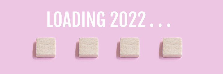 Wooden blocks with check mark on a pink background with copy space. Loading 2022. Checklist and plan concept
