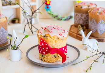 Traditional Easter cupcake, covered with sugar fondant, on a ceramic plate on a light concrete background.