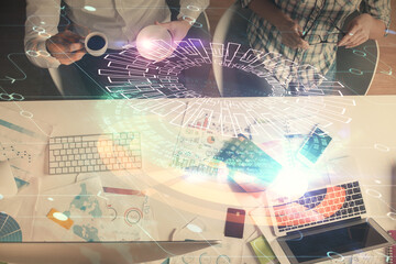 Double exposure of man and woman working together and data theme hologram drawing. Computer background. Top View.