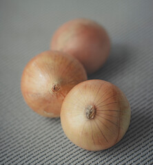 Close up group of onions on gray background
