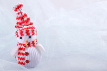 toy snowman on a light background. New Year's decor. postcard for the new year. minimalism. space...