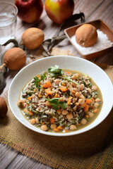 Brown rice soup with chickpeas, spinach and carrots - closeup