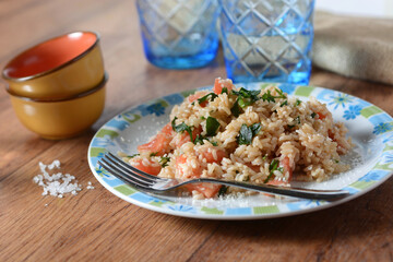 brown rice with chopped tomatoes and parsley - closeup