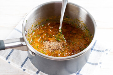 Spicy sauce from yellow plums, garlic, hot pepper, cilantro, dill and mint, known as tkemali. Georgian cuisine. Preserving