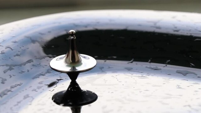 zinc gyroscope spinning on isolated glass background, video for meditation