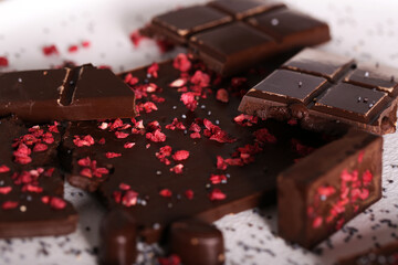 chocolate with dry raspberries lies on a light background