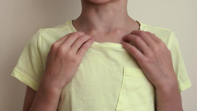 Young child practicing EFT or emotional freedom technique - tapping on the collarbone point