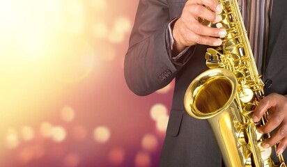 Beautiful golden saxophone on bokeh background,