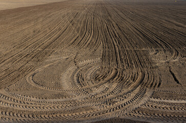 Fototapeta premium Tread marks on a plowed field