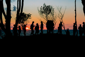figures of people against the setting sun