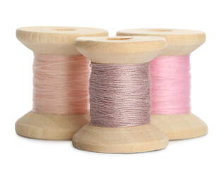 Different colorful sewing threads on white background, closeup