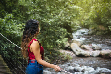 Woman in nature on a bridge