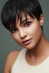 Portrait of beautiful young woman with short hair and and nice makeup on her face isolated on...