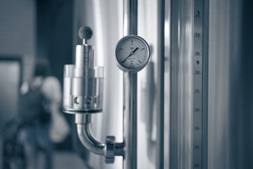 Manometers on steel cylinder storages or vats or tanks on beer and cider production plant, industry...