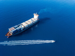 Aerial view on boat and container ship. Shipping cargo. Export, import and logistic