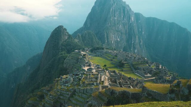 Machu Picchu citadel illuminated by the morning sun, Inca settlement. View from the top. No people.