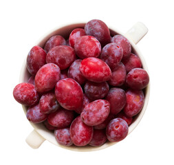 Bowl with ripe sweet plums isolated on a white background