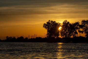 sunset over danube river, near sulina, romania