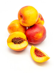 sliced and whole nectarines heap on white background