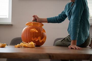 Child finishing a homemade halloween pumpkin
