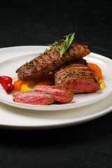 Grilled steaks cut on slices on a plate