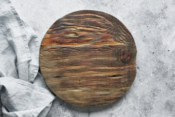 Wooden cutting board or pizza board on grey concrete background. Table top view and copy space for text. Restaurant menu, recipe, food background mock up.Top view