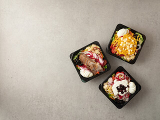 Variety of salads in takeaway containers